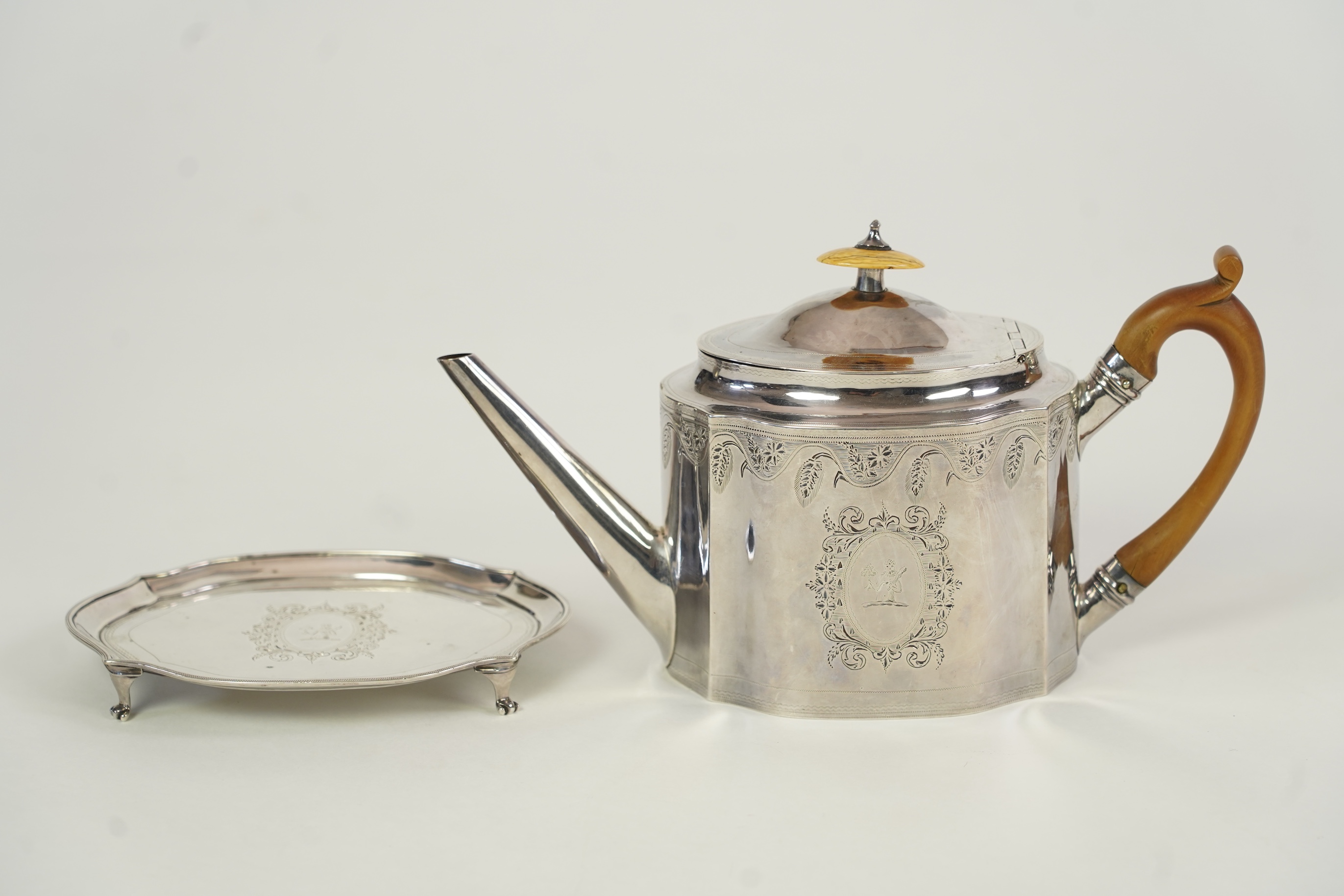 A George III silver teapot and matching stand, by Soloman Hougham